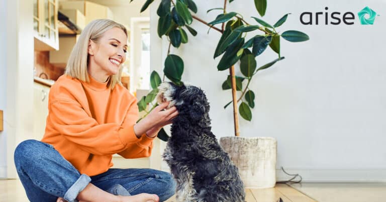 Woman sitting on the floor, petting her dog.